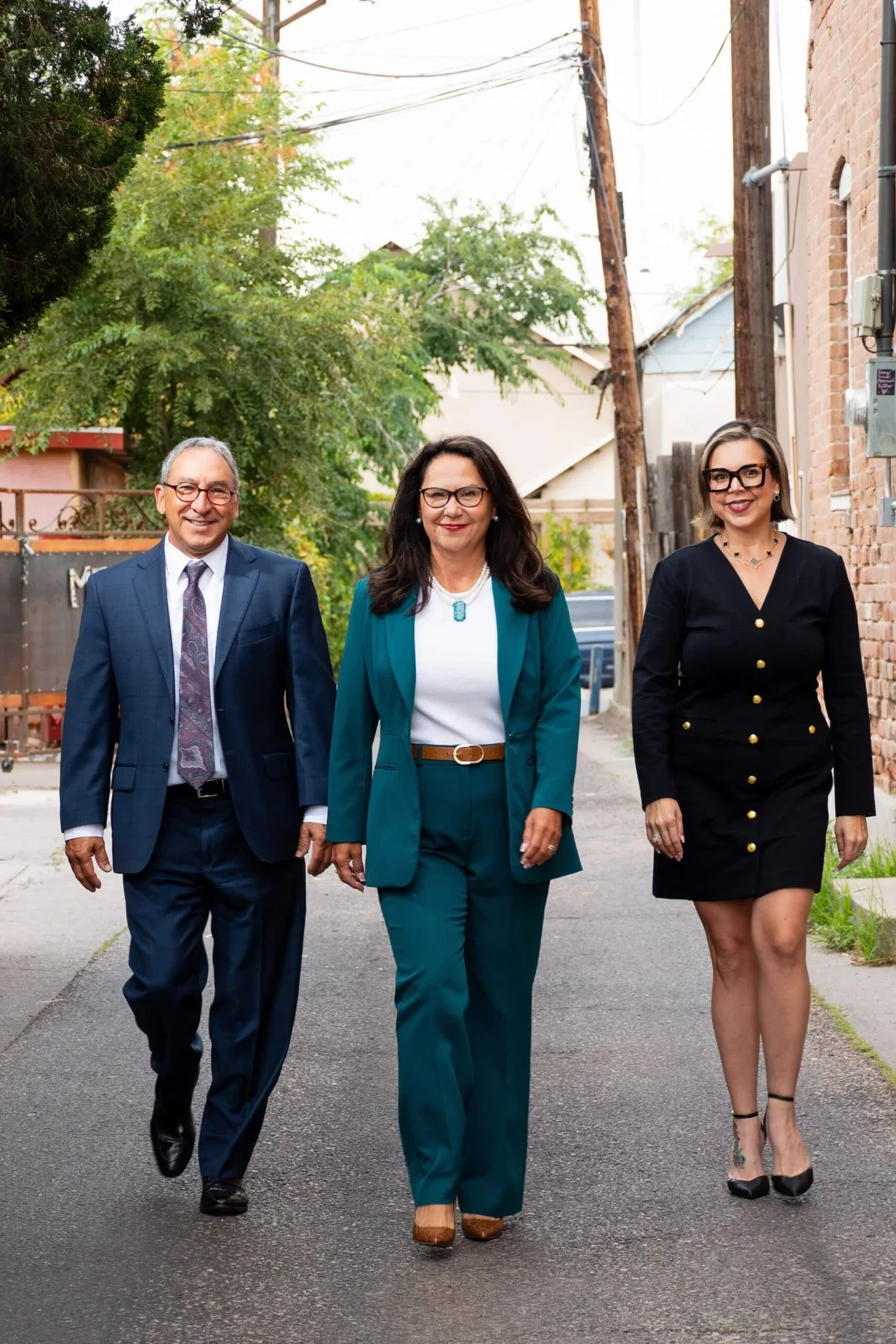 The attorneys of Peak Legal Group walking together in Albuquerque